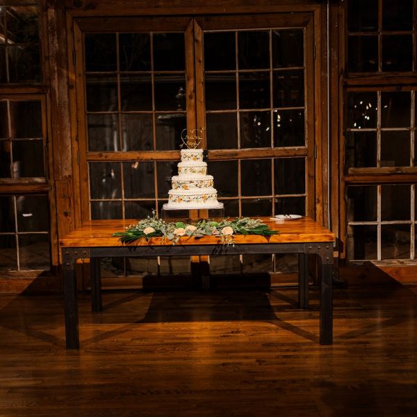 Wedding cake on rustic table in the Event Hall.