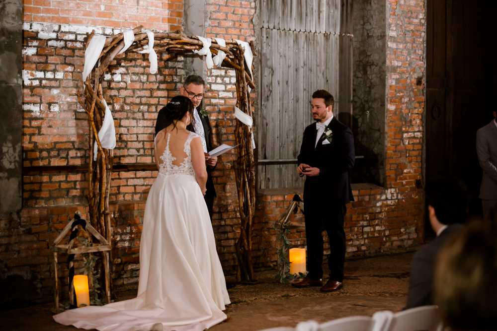 Couple facing each other at the altar during outdoor wedding ceremony.