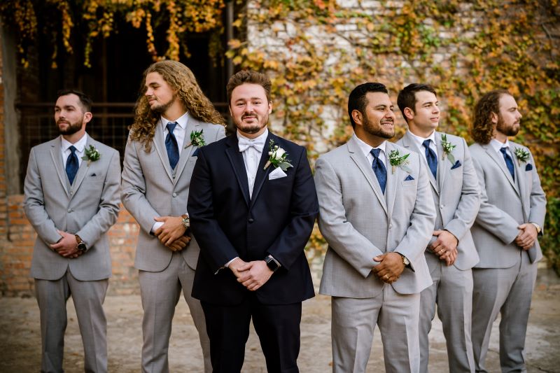 Groom and groomsmen pose for group portrait.