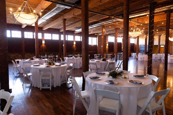 Wedding reception tables in the rustic industrial Event Hall.