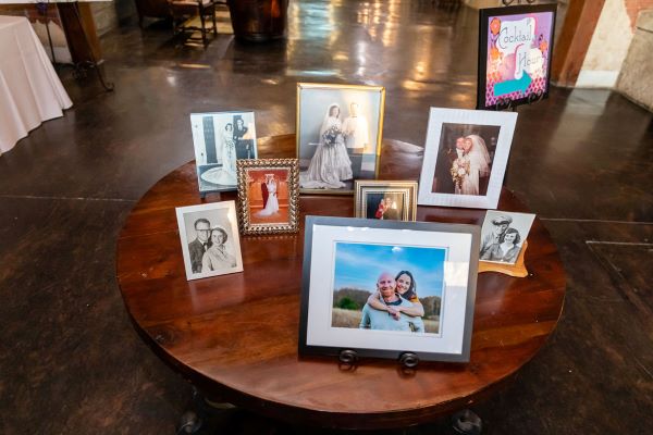 Small wooden table with wedding couple pictures in the Grand Hall entrance.