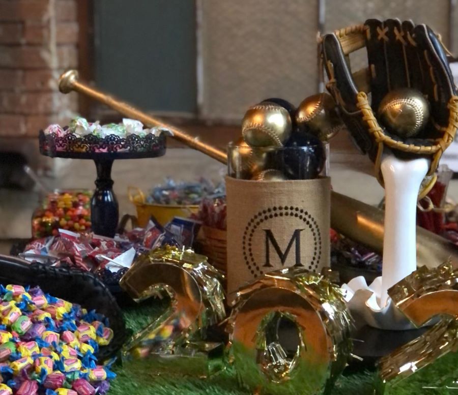 Candy and baseball decor on table.