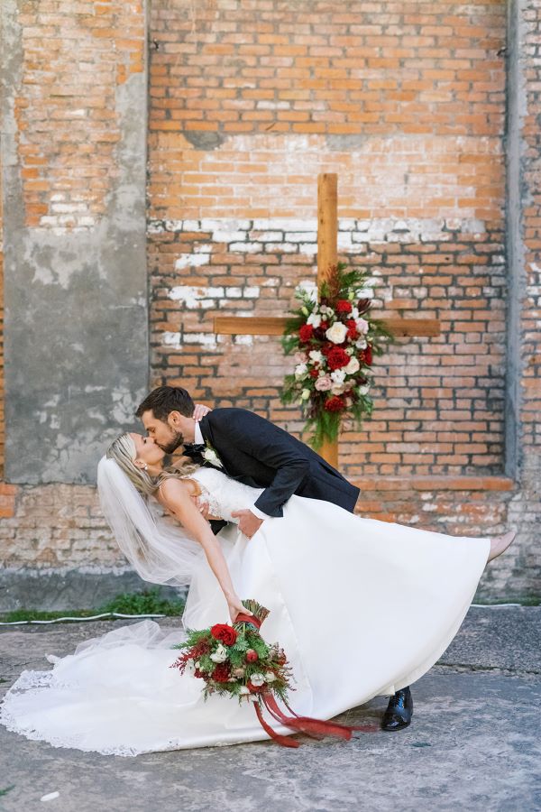 Couple kissing in front of altar.